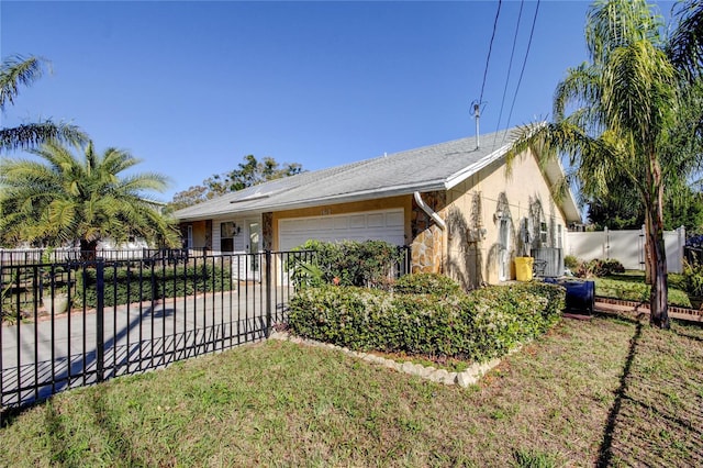 view of property exterior featuring stone siding, stucco siding, a garage, and fence