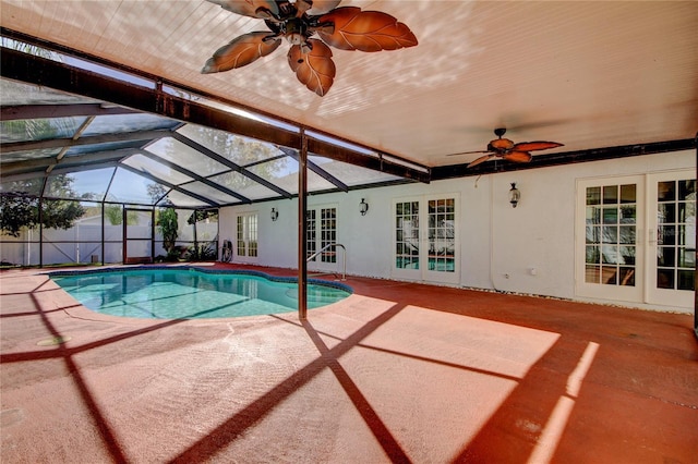 view of swimming pool with a ceiling fan, a fenced in pool, french doors, a lanai, and a patio area