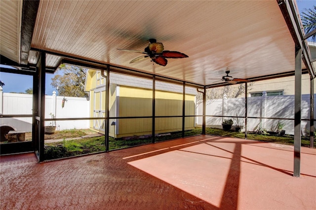 unfurnished sunroom featuring a ceiling fan