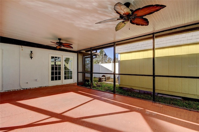 unfurnished sunroom featuring ceiling fan