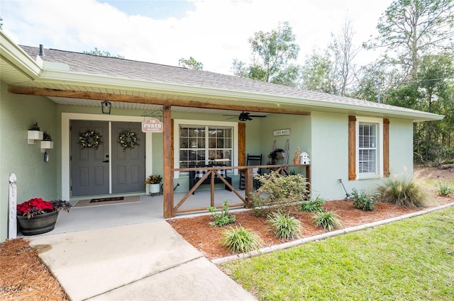 doorway to property with a porch and ceiling fan