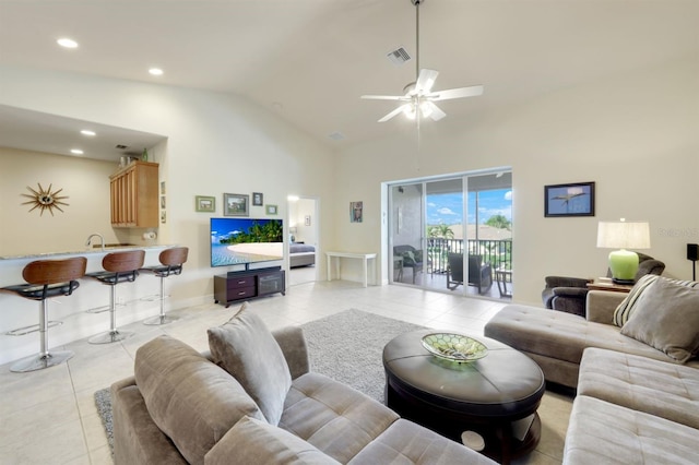 living room with ceiling fan, light tile patterned floors, and high vaulted ceiling