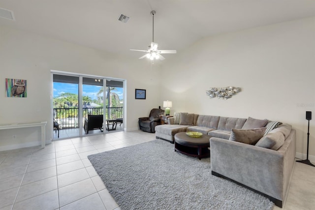 living room with high vaulted ceiling, ceiling fan, and light tile patterned flooring