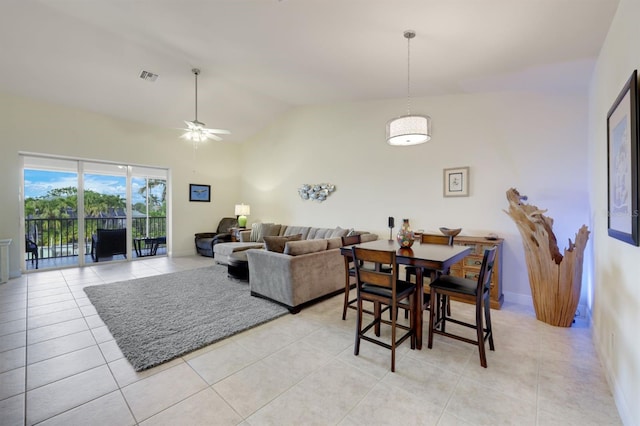 tiled dining space featuring ceiling fan and lofted ceiling