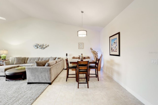 tiled dining space with vaulted ceiling