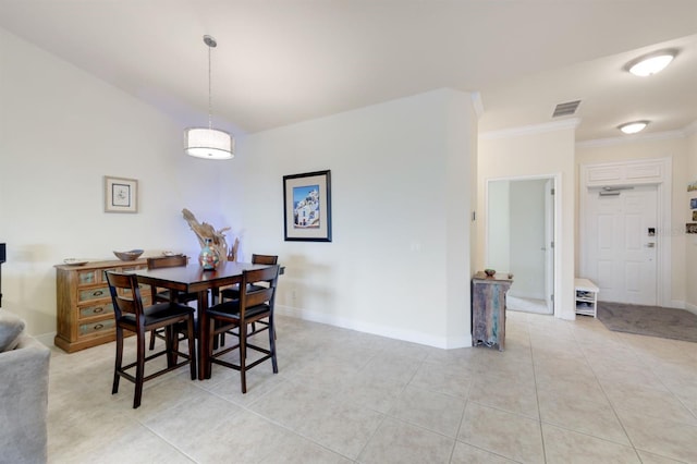 tiled dining area featuring ornamental molding