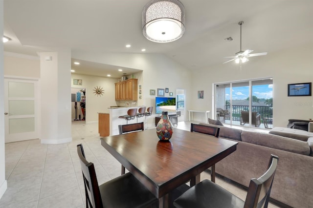 tiled dining room featuring ceiling fan and high vaulted ceiling