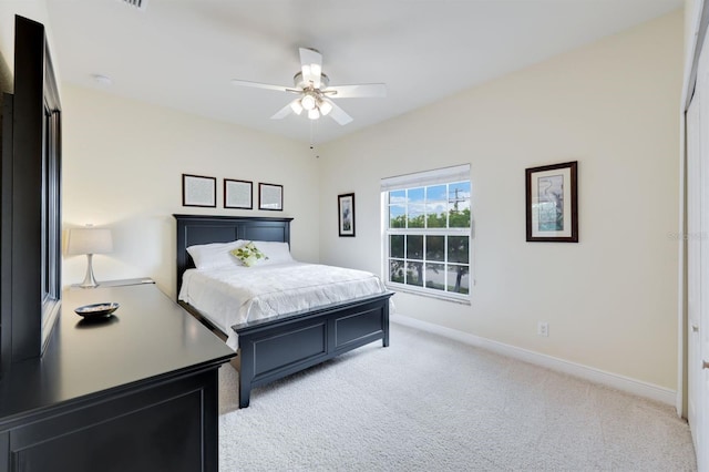 bedroom with ceiling fan and light carpet