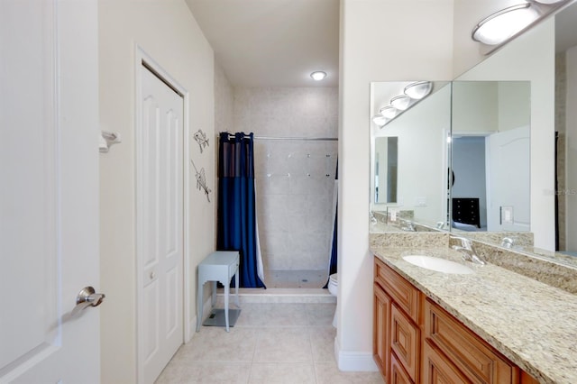 bathroom featuring a shower with shower curtain, vanity, tile patterned flooring, and toilet