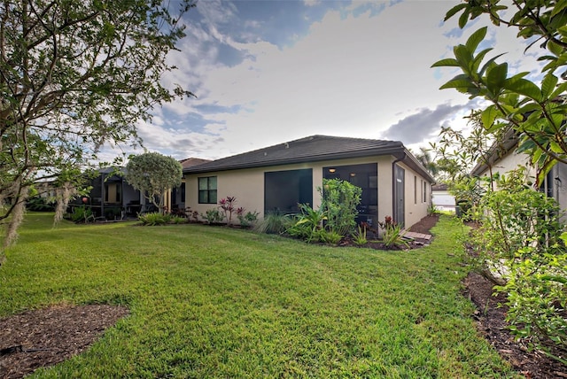 rear view of property with a yard