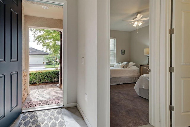 tiled foyer entrance with ceiling fan