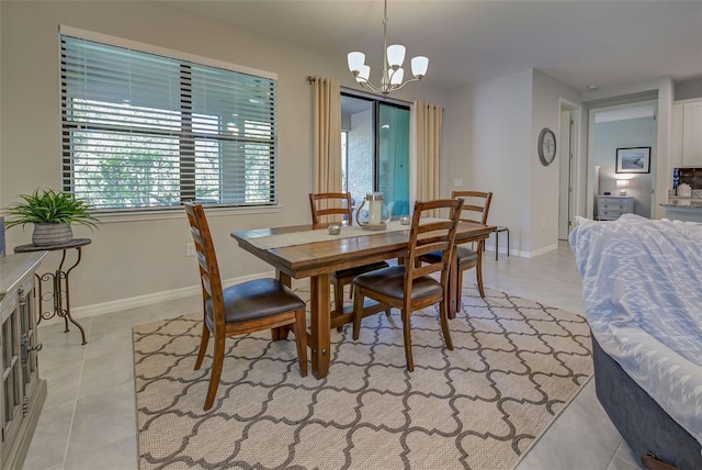 dining area with light tile patterned floors and an inviting chandelier