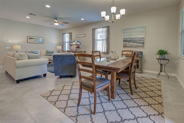 dining room with ceiling fan with notable chandelier and light tile patterned flooring