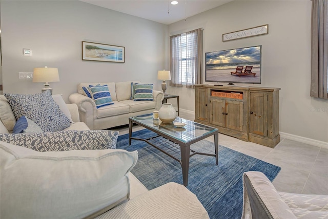 tiled living room with ceiling fan