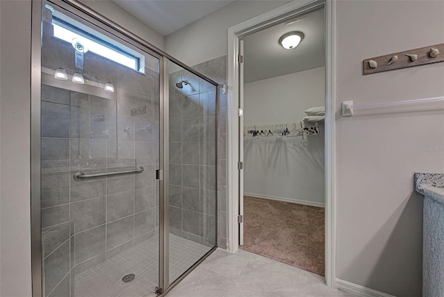 bathroom with tile patterned floors and walk in shower