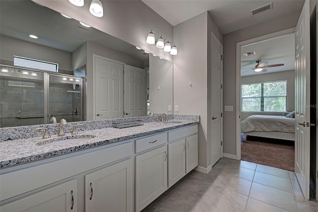 bathroom featuring tile patterned flooring, vanity, an enclosed shower, and ceiling fan