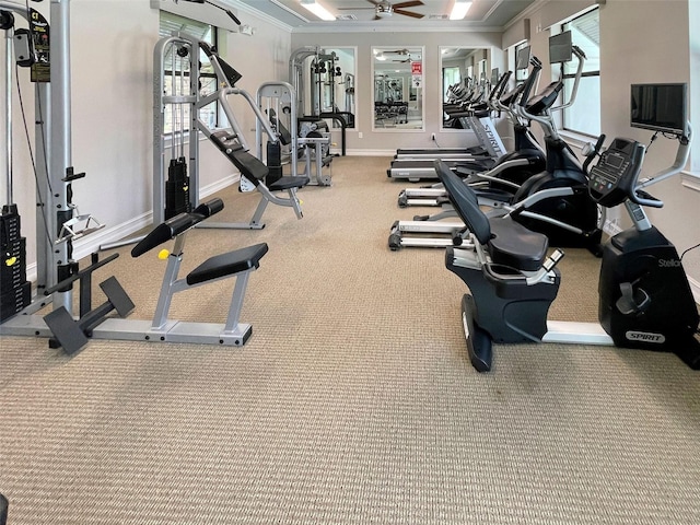 gym featuring plenty of natural light, ornamental molding, and ceiling fan