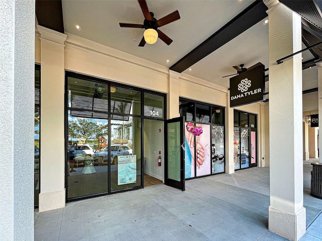 view of exterior entry featuring ceiling fan