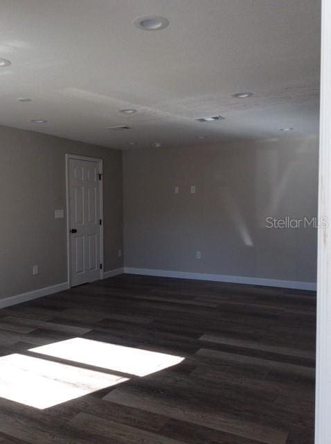 empty room featuring dark hardwood / wood-style flooring