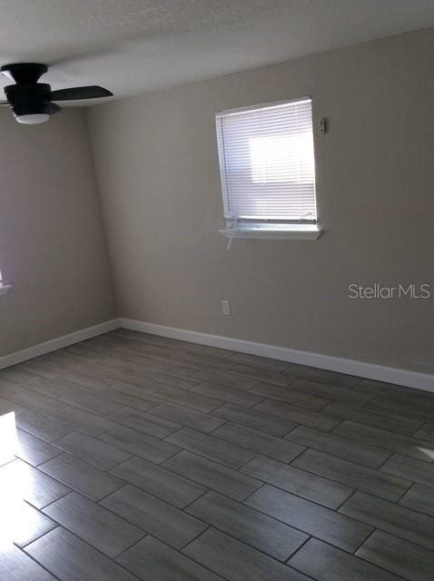 unfurnished room with hardwood / wood-style flooring and ceiling fan