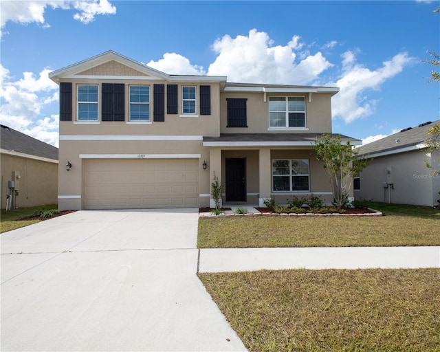 view of front of home with a front lawn and a garage