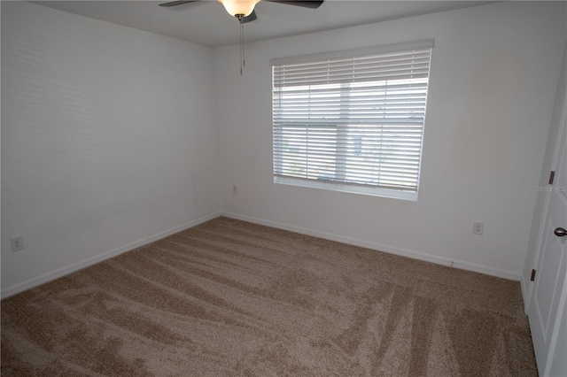 carpeted empty room featuring ceiling fan