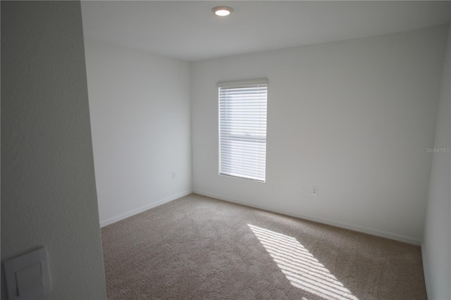 unfurnished room featuring carpet