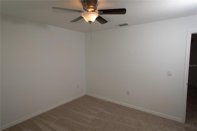 unfurnished room with ceiling fan and carpet