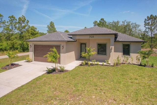 view of front of property with a garage and a front lawn