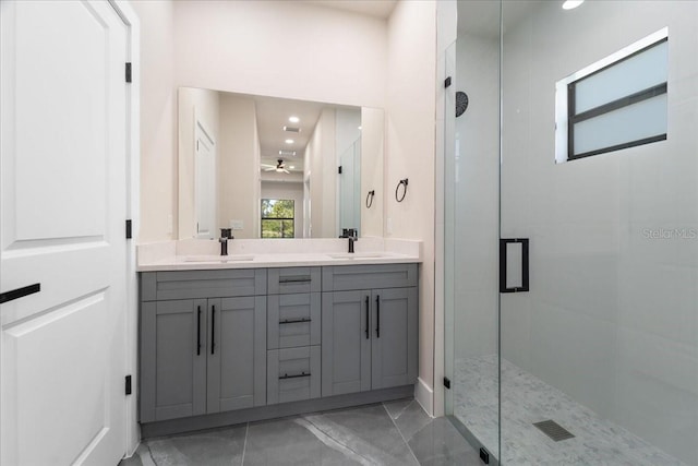 bathroom featuring ceiling fan, vanity, and an enclosed shower