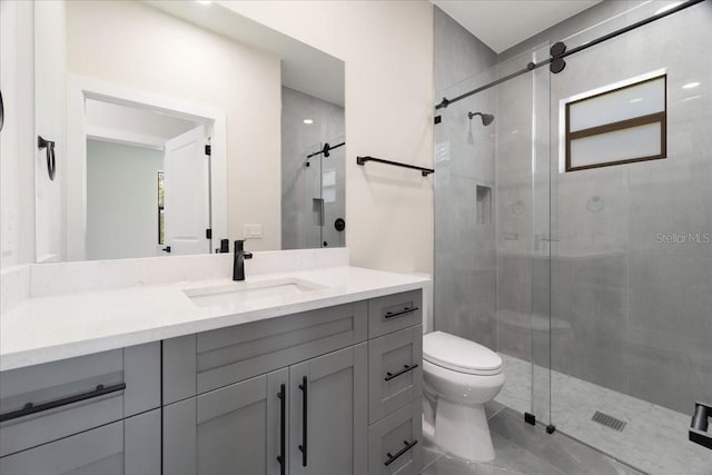 bathroom featuring walk in shower, vanity, and toilet