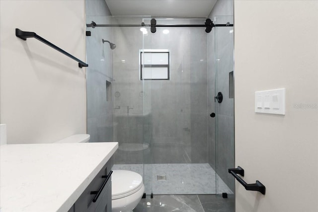 bathroom featuring walk in shower, vanity, and toilet