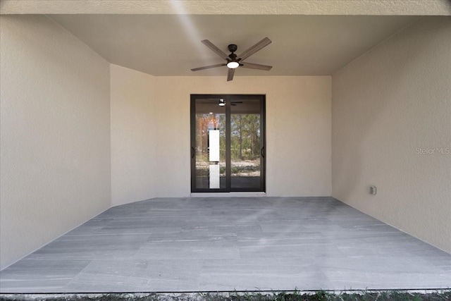 view of exterior entry featuring ceiling fan