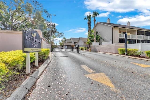 view of street featuring curbs, a gated entry, and a gate