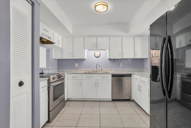 kitchen with white cabinetry, appliances with stainless steel finishes, sink, and light tile patterned floors