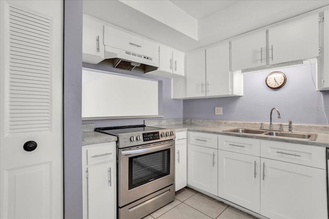 kitchen with stainless steel electric stove, light countertops, white cabinets, a sink, and under cabinet range hood