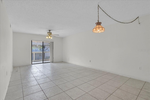 unfurnished room featuring ceiling fan, a textured ceiling, and light tile patterned floors