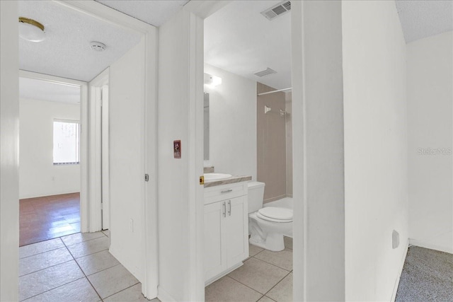 full bathroom with visible vents, vanity, toilet, and tile patterned floors