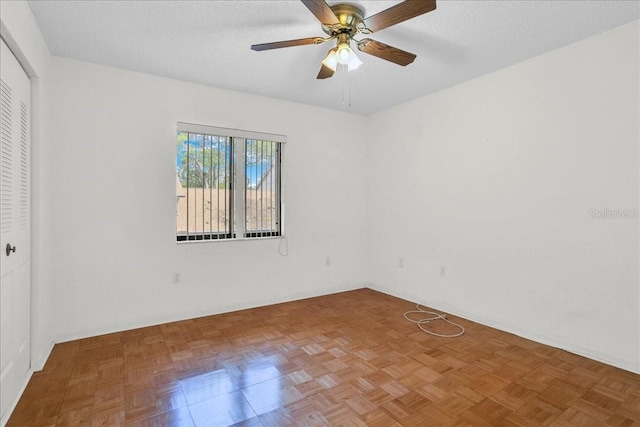 empty room featuring ceiling fan and a textured ceiling