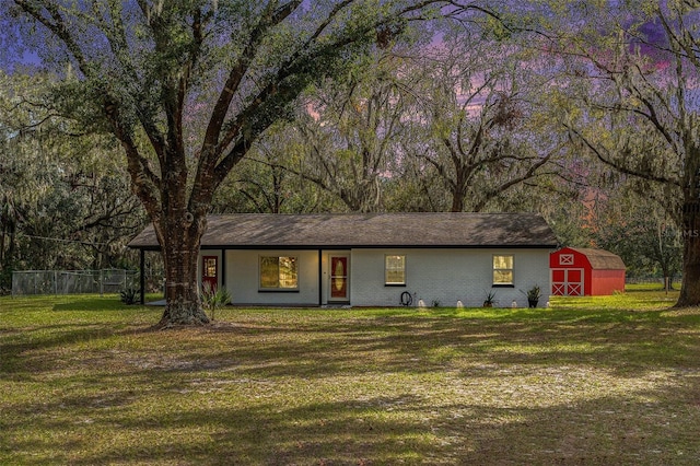 single story home with an outbuilding and a front lawn