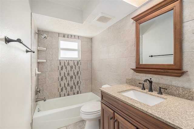 full bathroom with vanity, tiled shower / bath combo, toilet, a textured ceiling, and tile walls