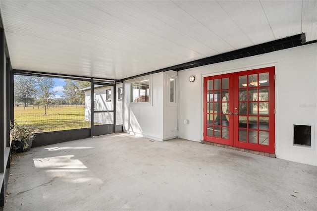 unfurnished sunroom with french doors