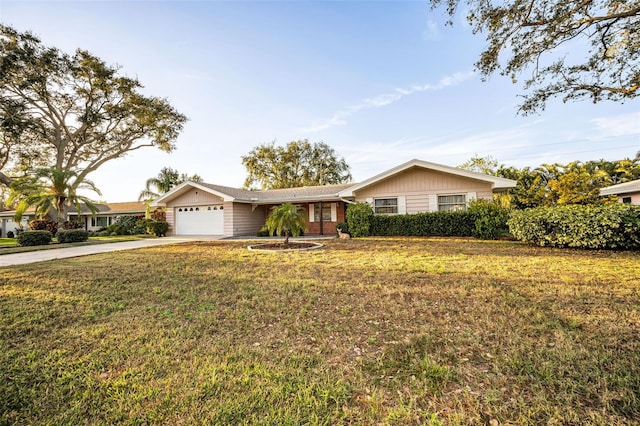 ranch-style house featuring a front yard and a garage