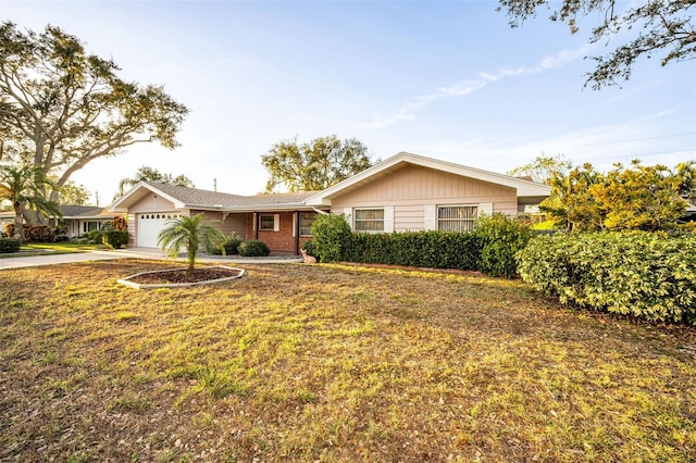 ranch-style house with a front yard and a garage