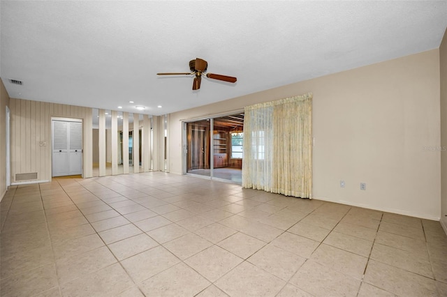 spare room featuring light tile patterned floors, a textured ceiling, and ceiling fan