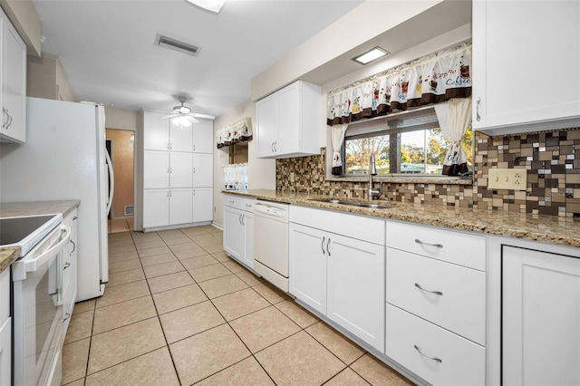 kitchen with white cabinets, light tile patterned floors, white appliances, and sink