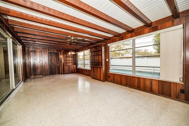 unfurnished sunroom with beamed ceiling