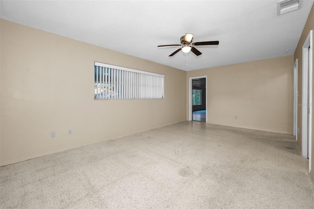 unfurnished room with ceiling fan and plenty of natural light