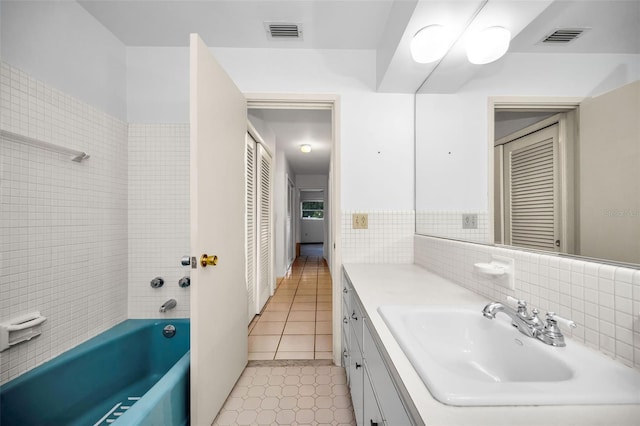 bathroom featuring vanity, tile patterned floors, and backsplash