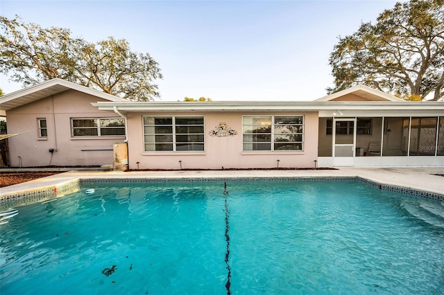 view of pool featuring a sunroom